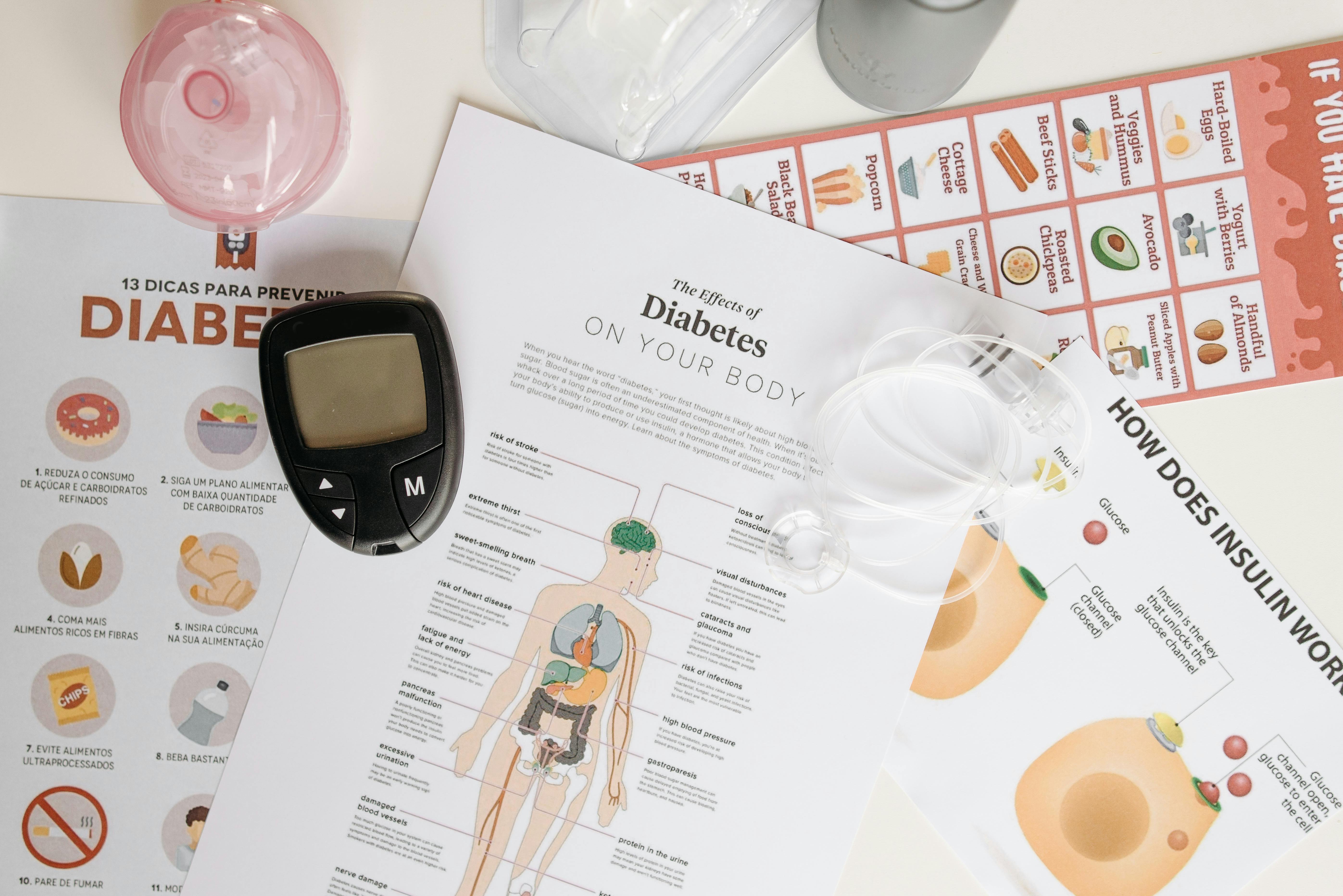 Glucometer and papers about diabetes on a table